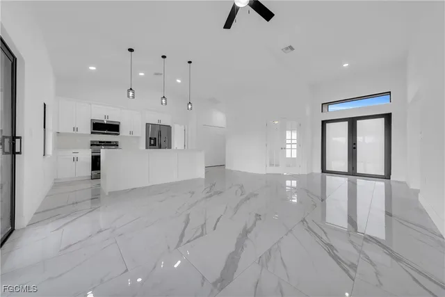 a view of a electric appliances in kitchen and an empty room