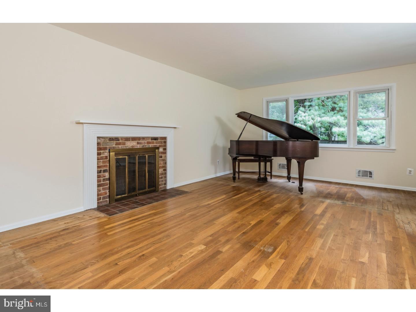 73 Robert Road Princeton, NJ 08540 - Photo 4 of 24 a view of an empty room with wooden floor and a window