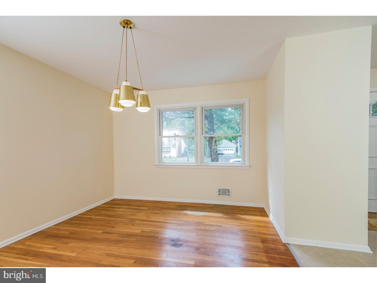 73 Robert Road Princeton, NJ 08540 - Photo 7 of 24 a view of an empty room with wooden floor and a window
