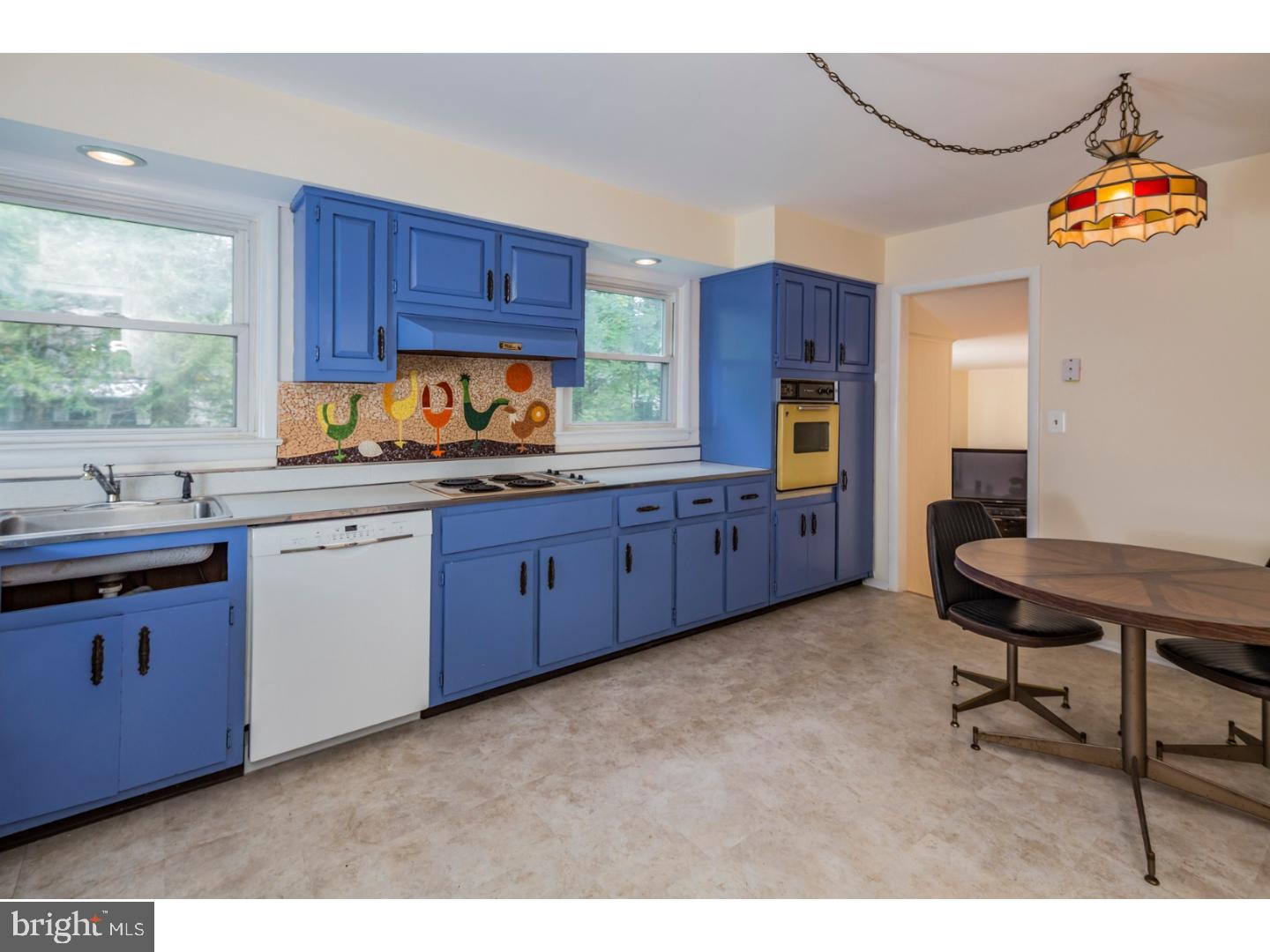 73 Robert Road Princeton, NJ 08540 - Photo 9 of 24 a kitchen with granite countertop wooden cabinets a stove a sink a dining table and chairs