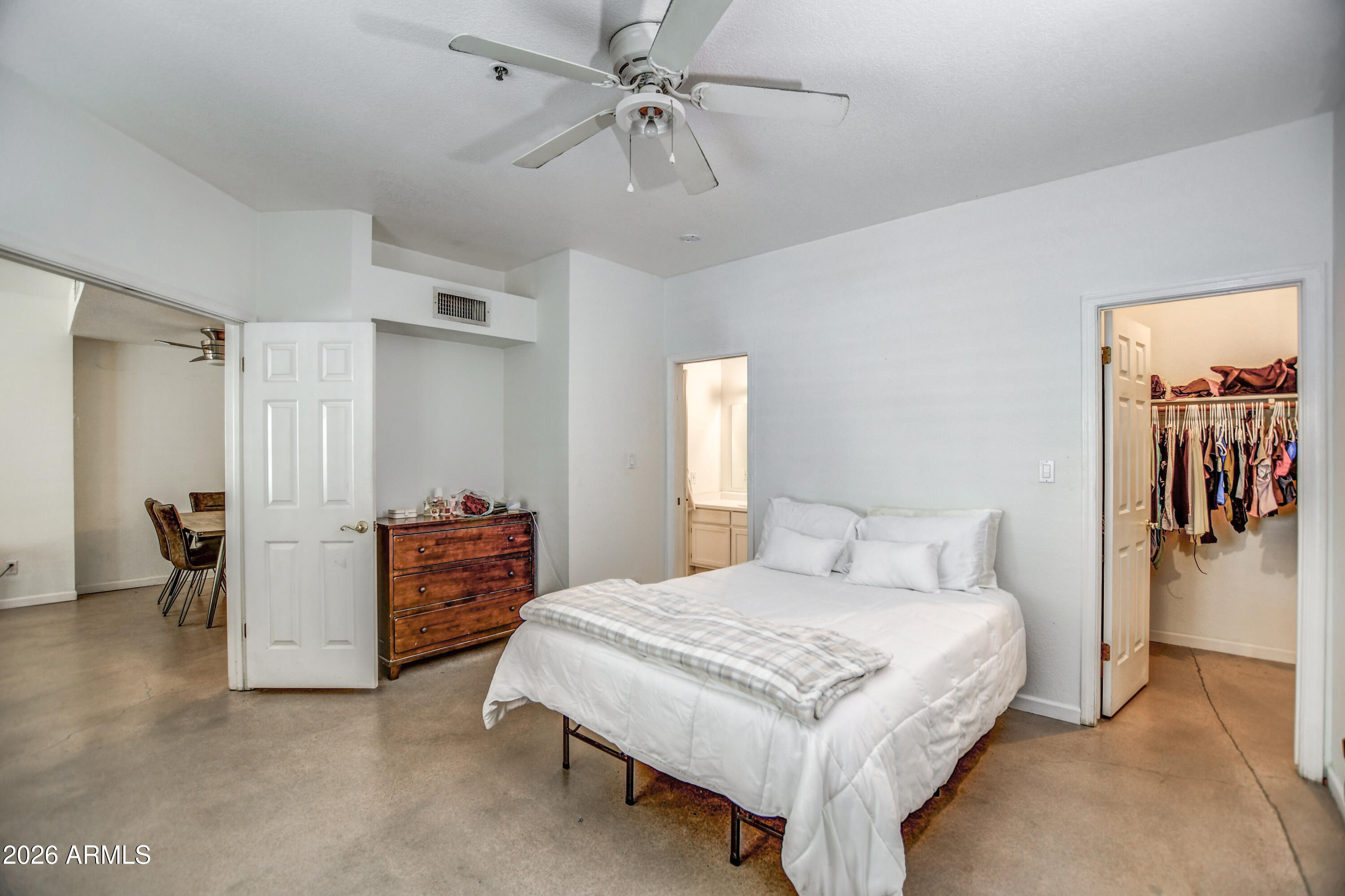 100 East Fillmore Street, Unit 117 Phoenix, AZ 85004 - Photo 18 of 20 a bedroom with a bed and a chandelier