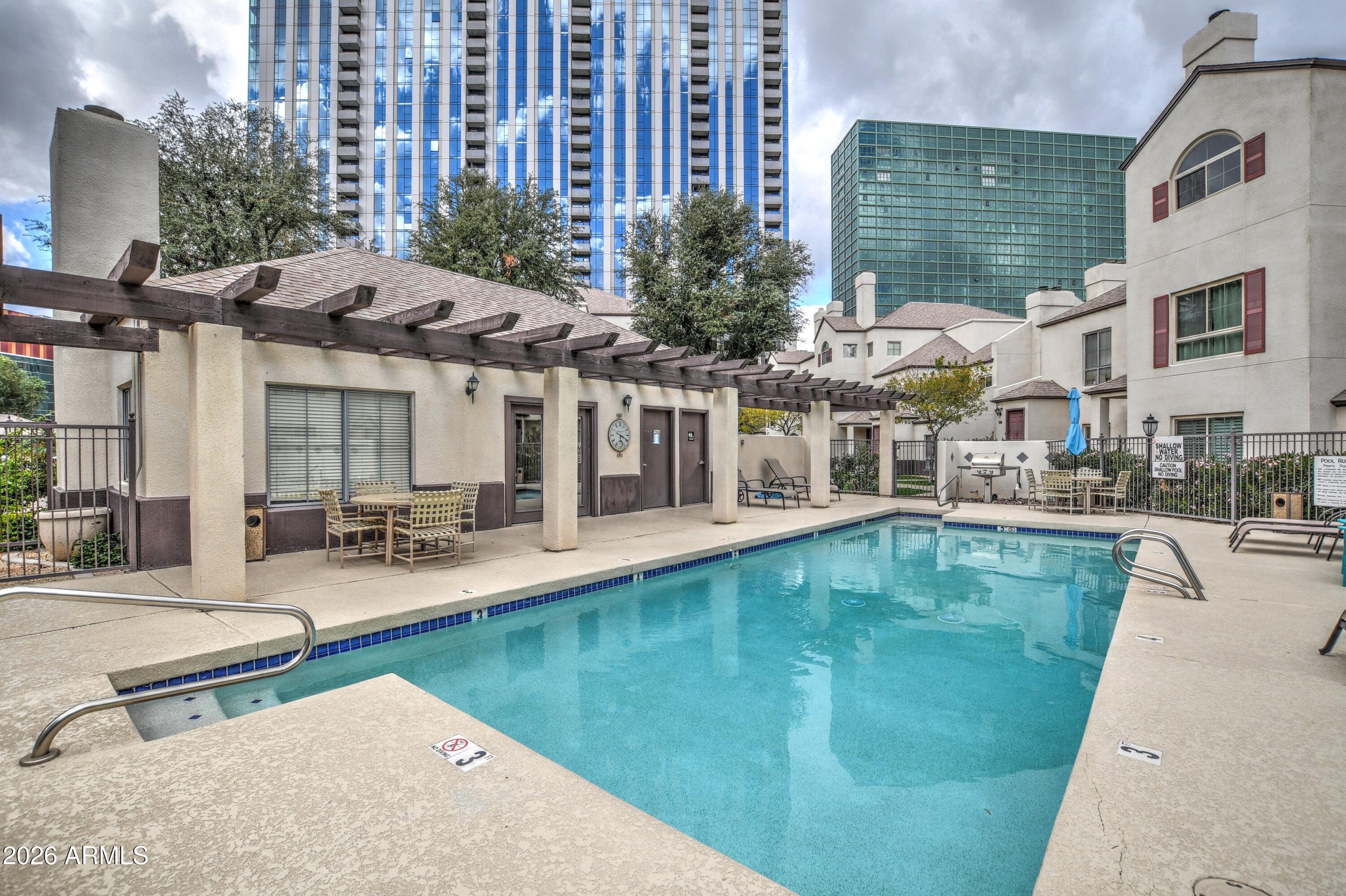 100 East Fillmore Street, Unit 117 Phoenix, AZ 85004 - Photo 2 of 20 a view of a swimming pool with outdoor seating