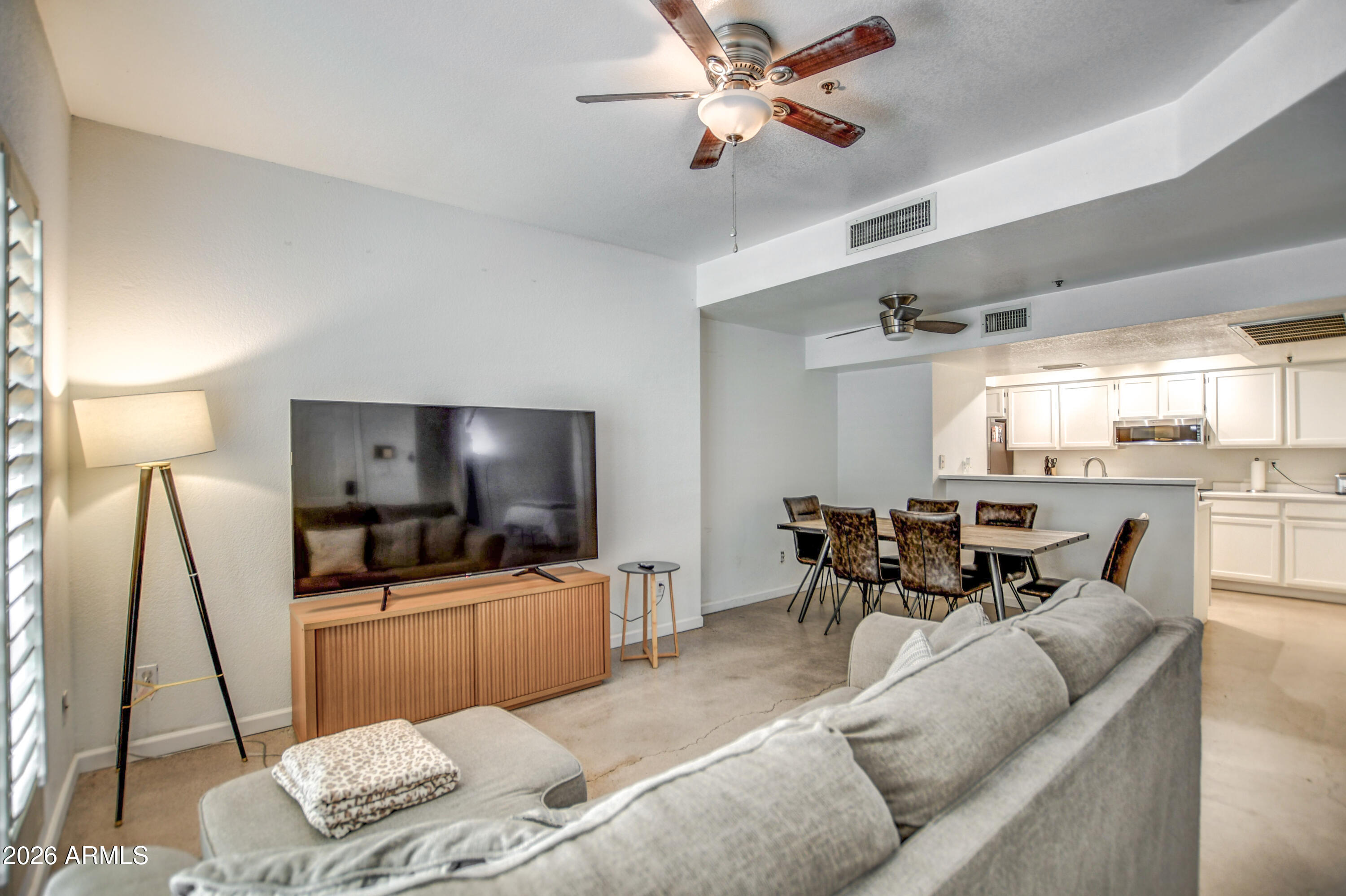 100 East Fillmore Street, Unit 117 Phoenix, AZ 85004 - Photo 7 of 20 a living room with furniture and a flat screen tv