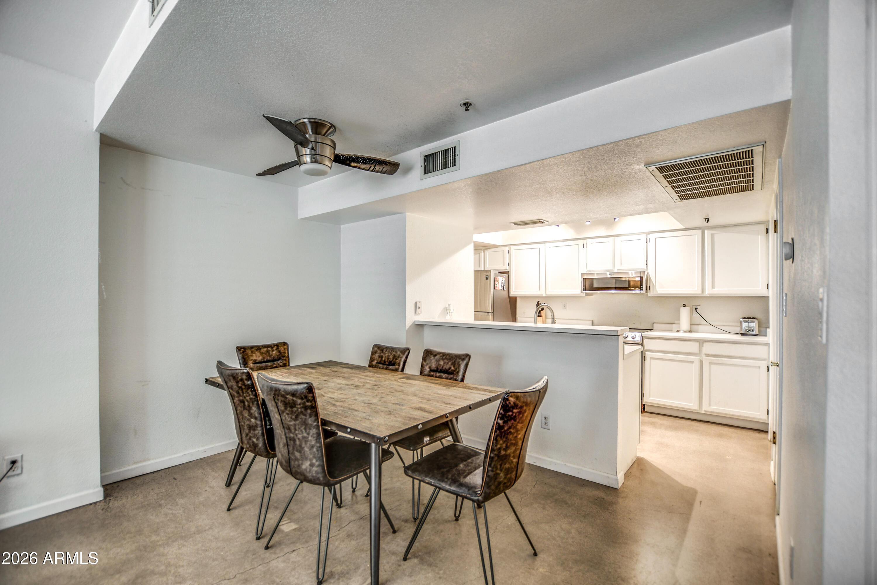 100 East Fillmore Street, Unit 117 Phoenix, AZ 85004 - Photo 8 of 20 a view of a dining room with furniture and wooden floor