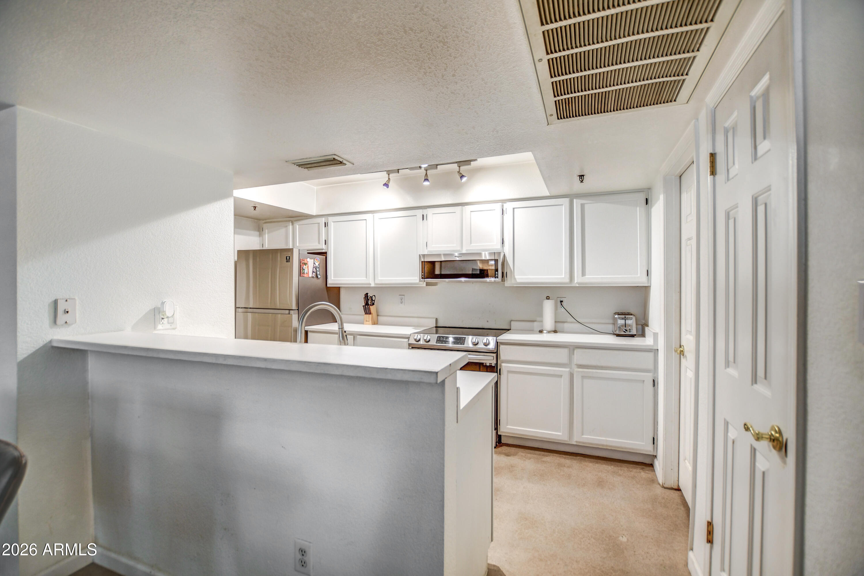 100 East Fillmore Street, Unit 117 Phoenix, AZ 85004 - Photo 10 of 20 a kitchen with stainless steel appliances a sink stove and cabinets