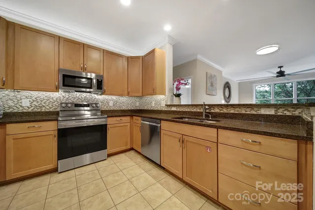 a kitchen with granite countertop a sink and cabinets