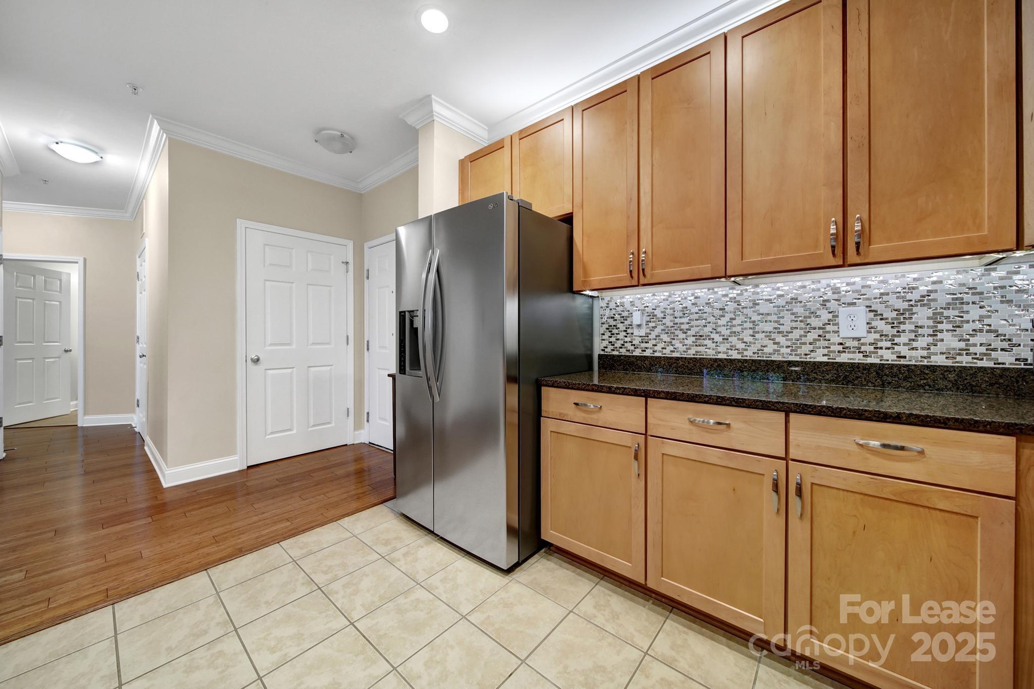 1000 East Woodlawn Road Charlotte, NC 28209 - Photo 6 of 29 a kitchen with stainless steel appliances granite countertop a refrigerator a stove and a sink