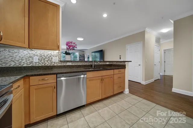 a kitchen with stainless steel appliances granite countertop a sink and cabinets