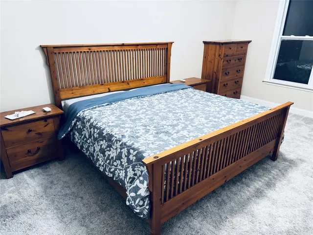 a bed sitting in a bedroom next to a window