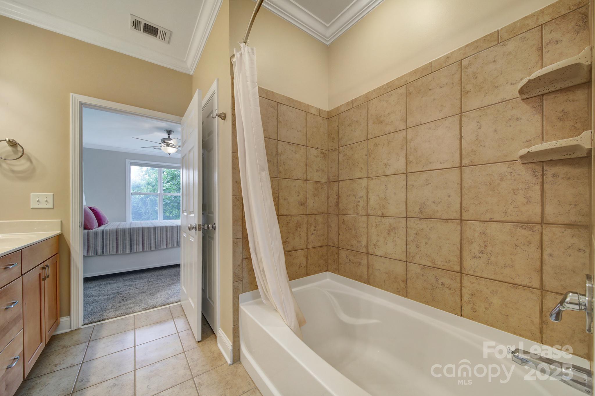 1000 East Woodlawn Road Charlotte, NC 28209 - Photo 10 of 29 a bathroom with a bathtub and a sink