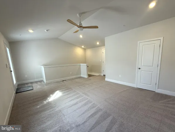 a view of a livingroom with a ceiling fan and window