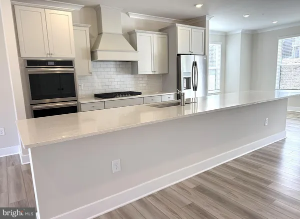 a kitchen with stainless steel appliances a sink stove and refrigerator