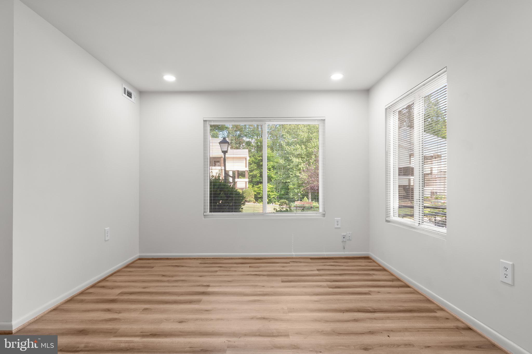10330 Luria Commons Court, Unit 1B Burke, VA 22015 - Photo 11 of 24 a view of an empty room with wooden floor and a window