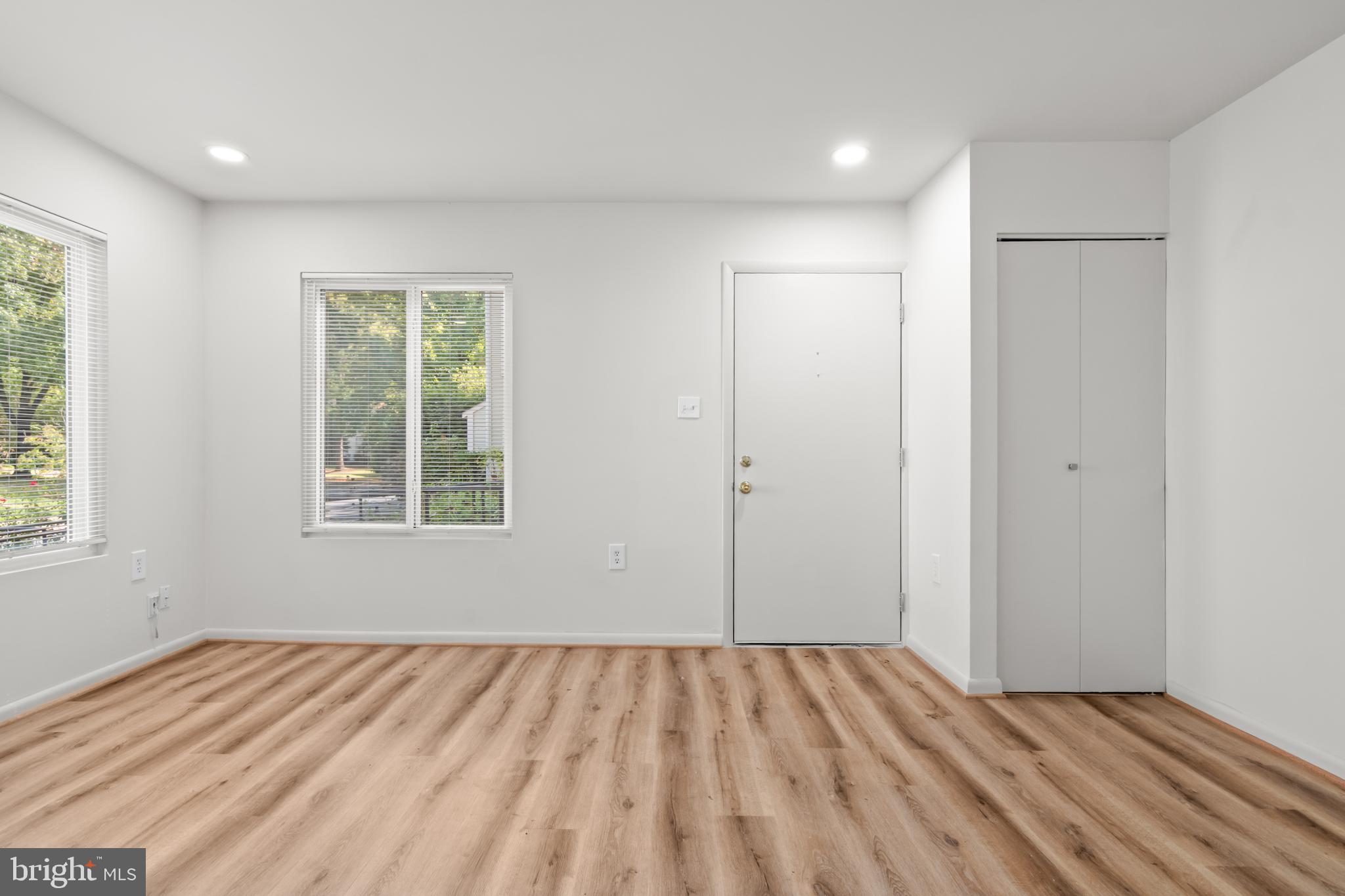 10330 Luria Commons Court, Unit 1B Burke, VA 22015 - Photo 13 of 24 a view of an empty room with wooden floor and a window