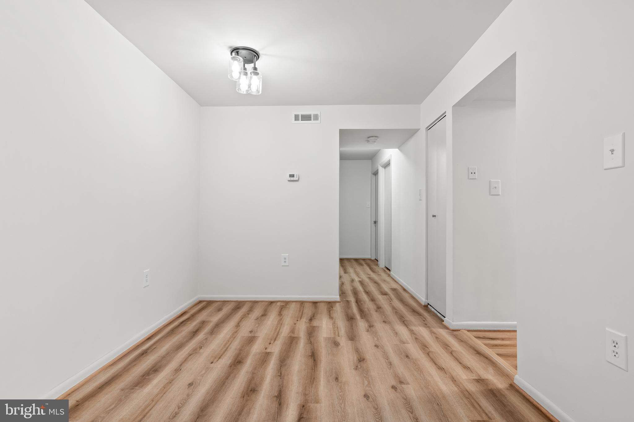 10330 Luria Commons Court, Unit 1B Burke, VA 22015 - Photo 14 of 24 a view of a room with wooden floor and a bathroom