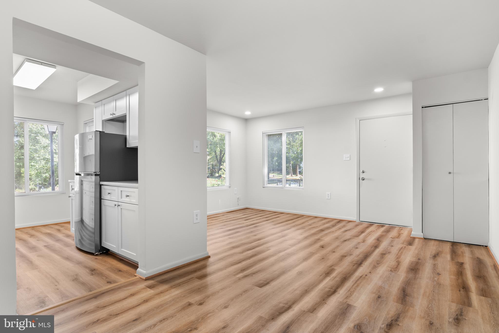 10330 Luria Commons Court, Unit 1B Burke, VA 22015 - Photo 16 of 24 a view of livingroom with hardwood floor and a kitchen