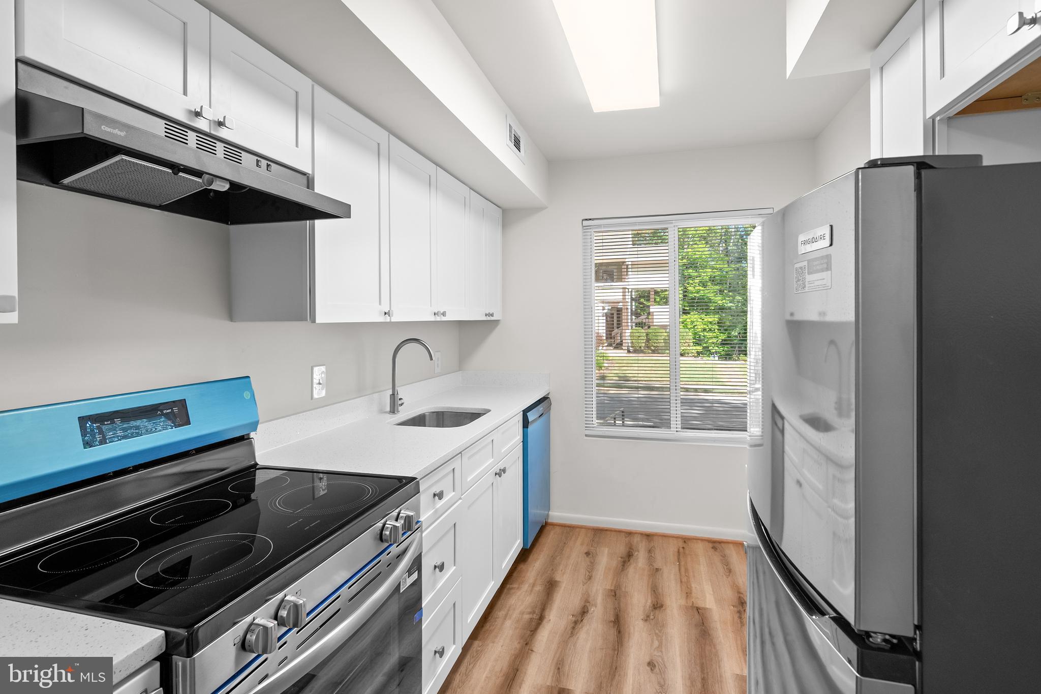 10330 Luria Commons Court, Unit 1B Burke, VA 22015 - Photo 19 of 24 a kitchen that has a sink stainless steel appliances a window and a counter top space