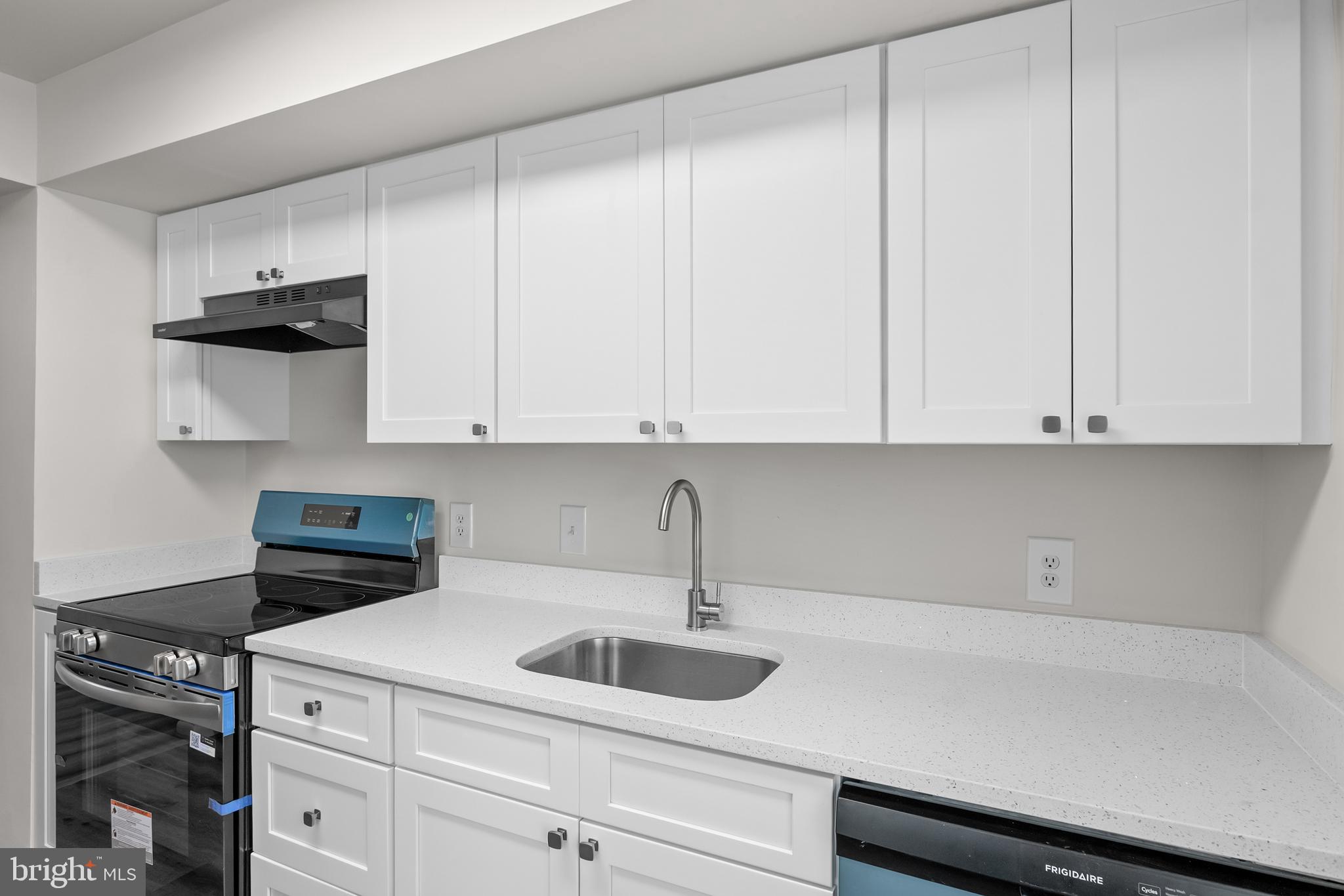 10330 Luria Commons Court, Unit 1B Burke, VA 22015 - Photo 20 of 24 a kitchen with white cabinets and sink