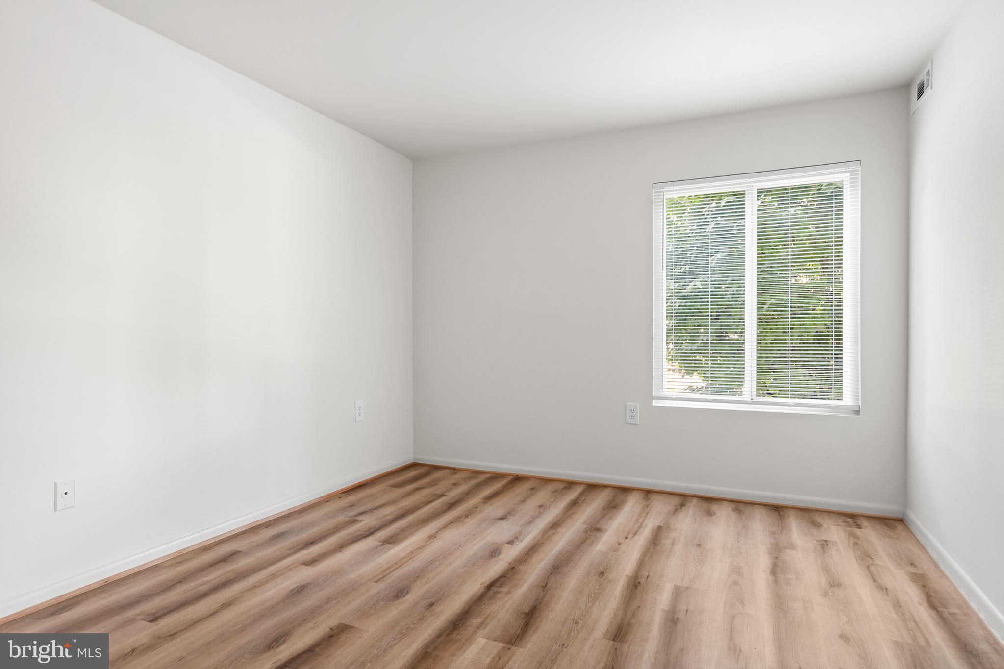 10330 Luria Commons Court, Unit 1B Burke, VA 22015 - Photo 2 of 24 an empty room with a window