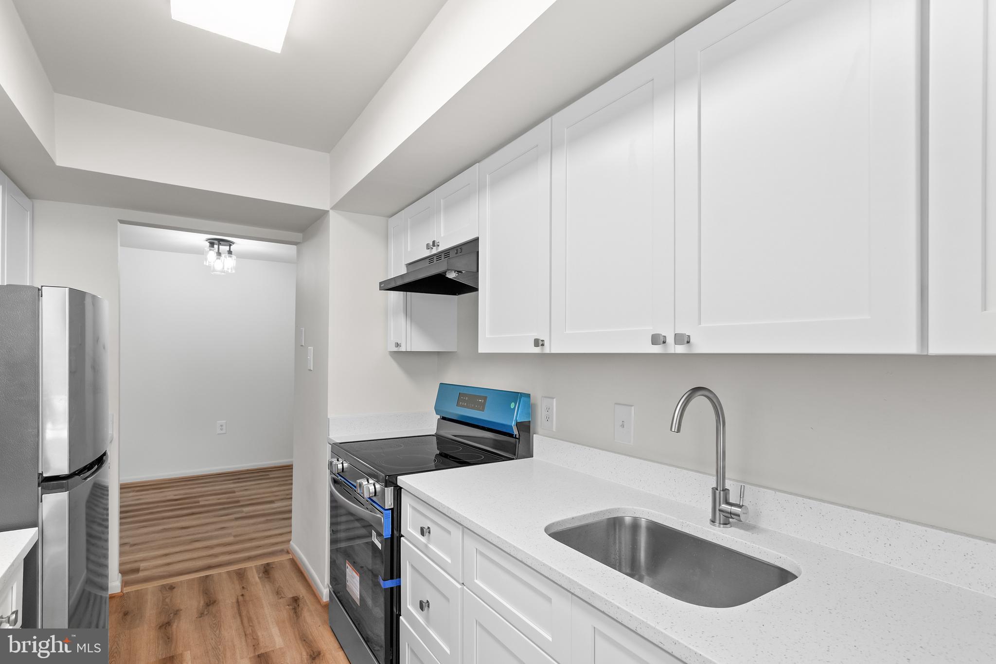 10330 Luria Commons Court, Unit 1B Burke, VA 22015 - Photo 21 of 24 a kitchen with a sink cabinets and stainless steel appliances