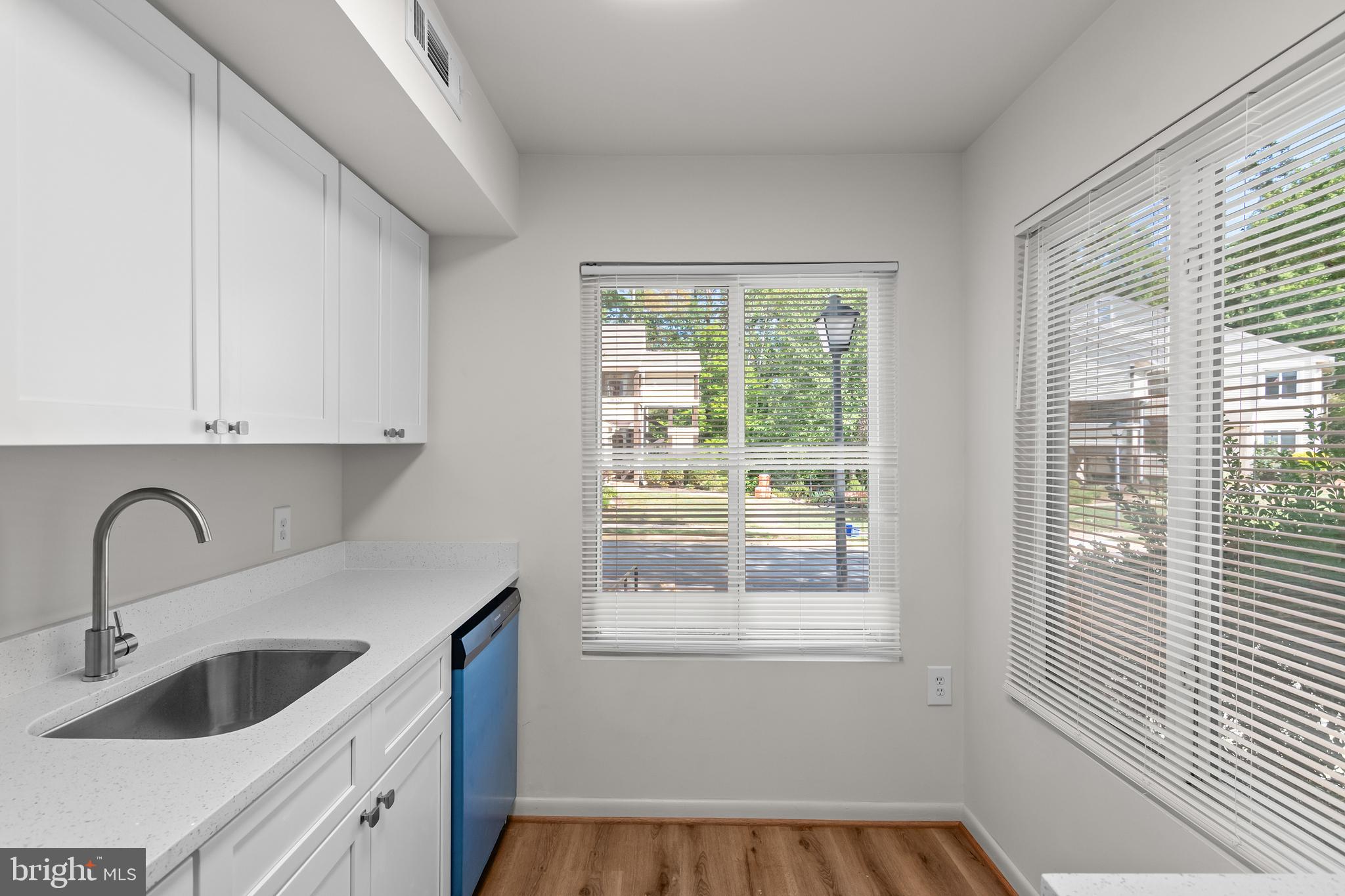 10330 Luria Commons Court, Unit 1B Burke, VA 22015 - Photo 22 of 24 a kitchen with granite countertop a sink and a window