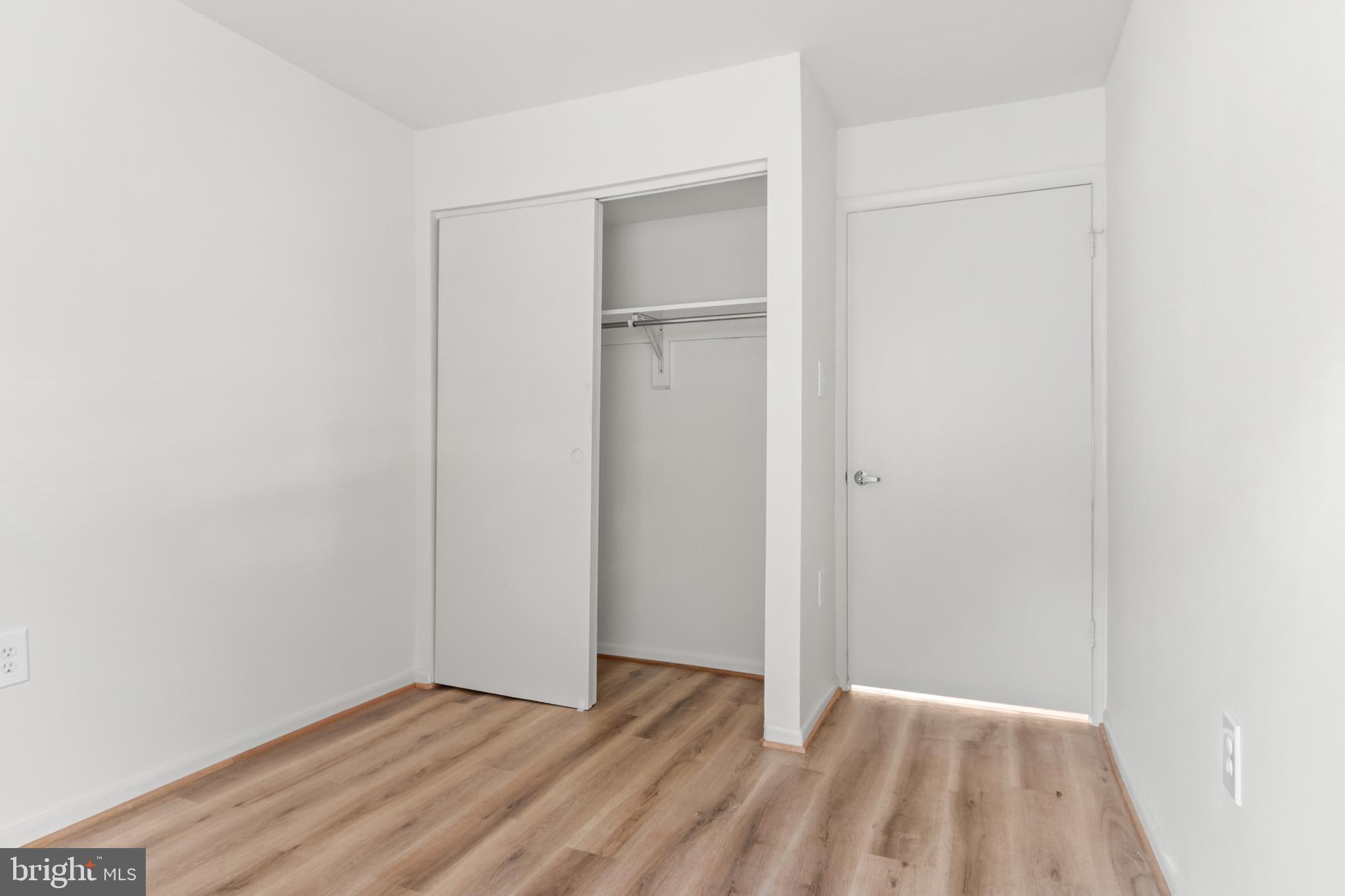10330 Luria Commons Court, Unit 1B Burke, VA 22015 - Photo 24 of 24 a view of an empty room with wooden floor