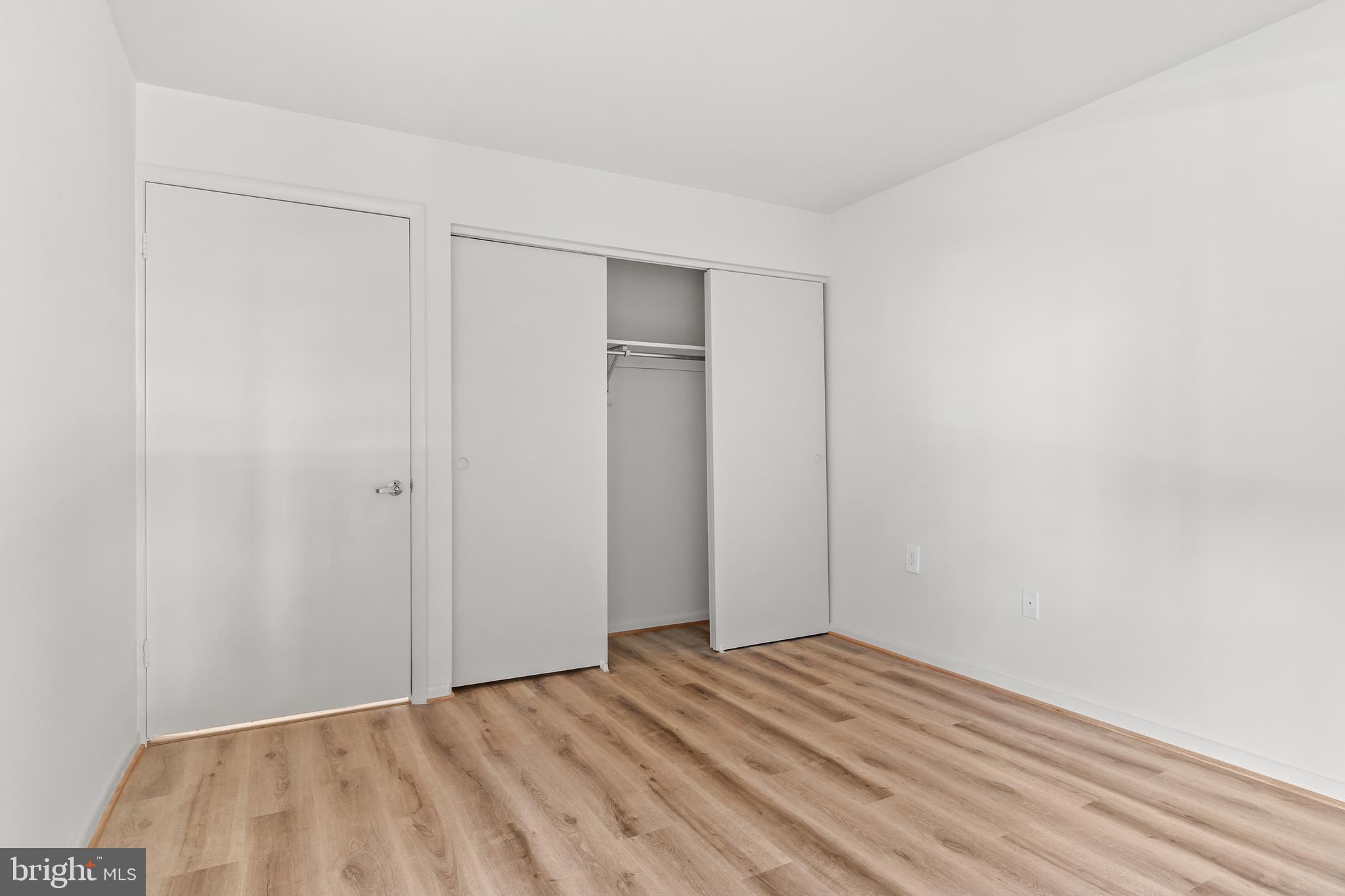10330 Luria Commons Court, Unit 1B Burke, VA 22015 - Photo 3 of 24 a view of empty room with wooden floor