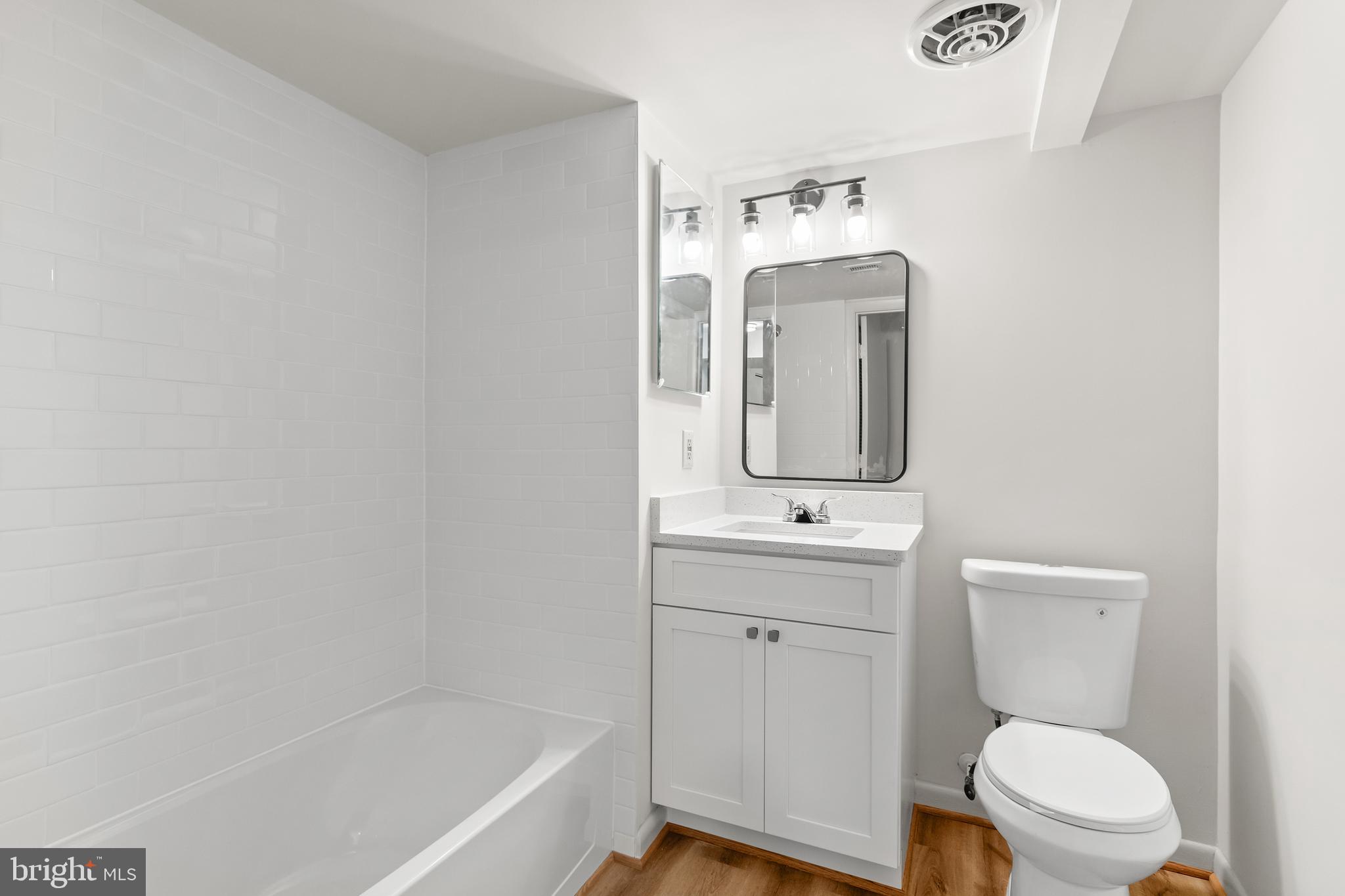 10330 Luria Commons Court, Unit 1B Burke, VA 22015 - Photo 4 of 24 a bathroom with a toilet a sink and mirror