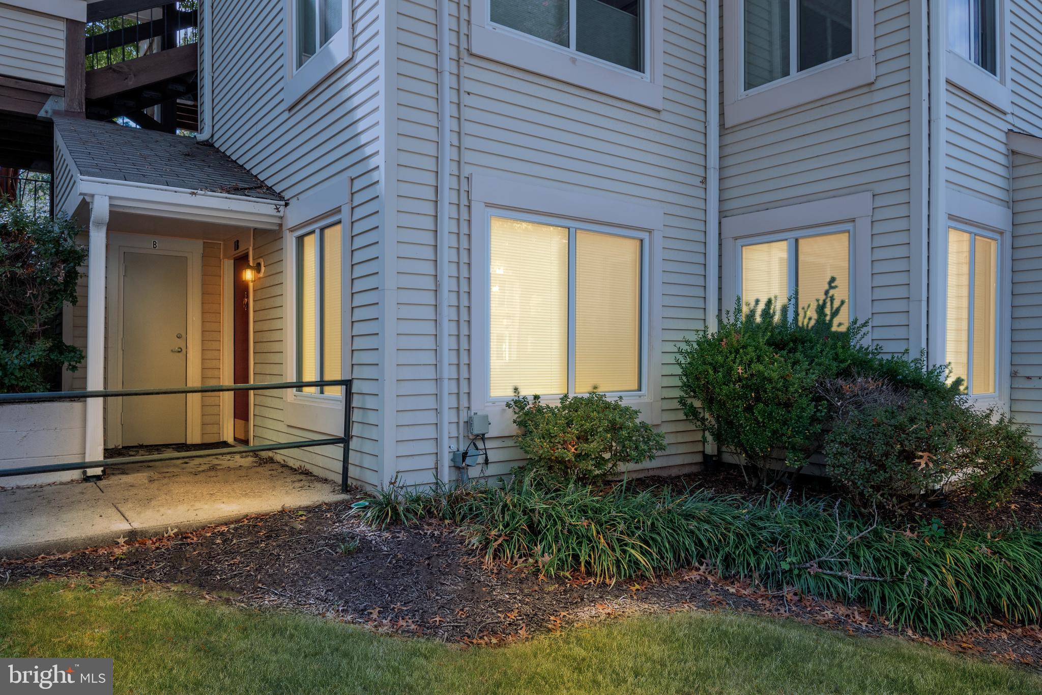 10330 Luria Commons Court, Unit 1B Burke, VA 22015 - Photo 8 of 24 a view of a backyard with plants and brick wall