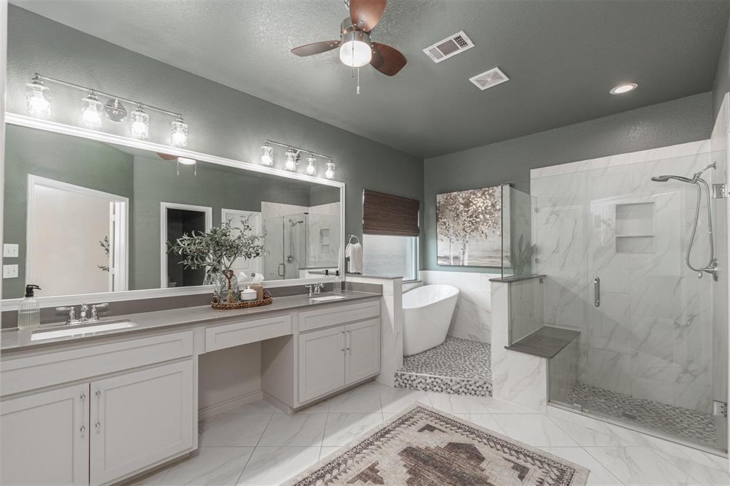 400 Prairie Run Aledo, TX 76008 - Photo 11 of 36 a large bathroom with a double vanity sink a large mirror and a bathtub