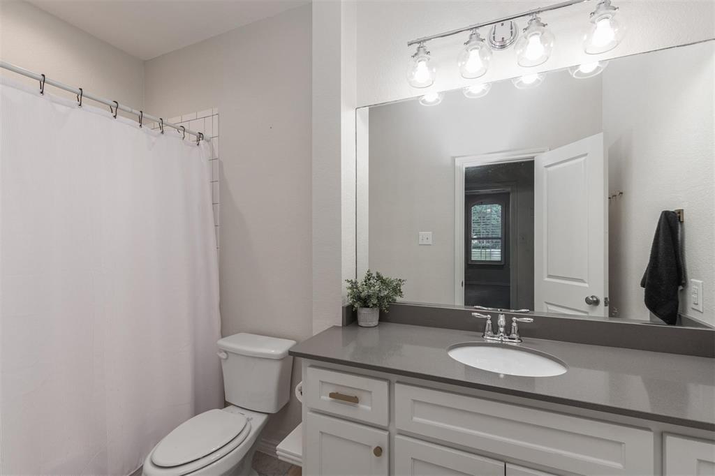 400 Prairie Run Aledo, TX 76008 - Photo 16 of 36 a bathroom with a granite countertop sink vanity mirror and toilet