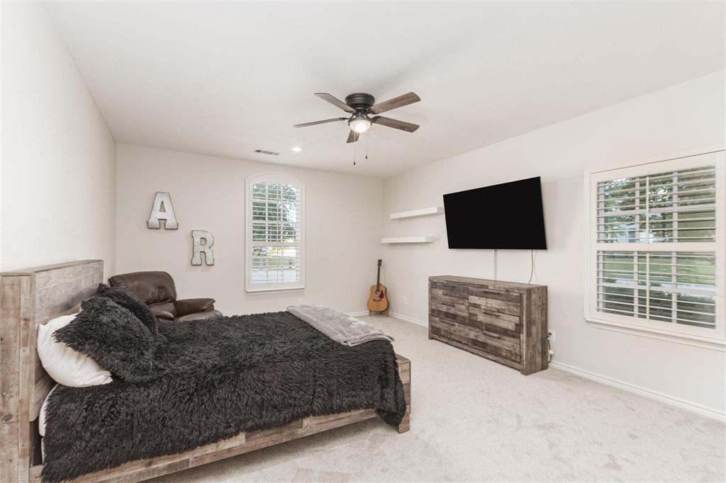 400 Prairie Run Aledo, TX 76008 - Photo 17 of 36 a living room with furniture a flat screen tv and a fireplace