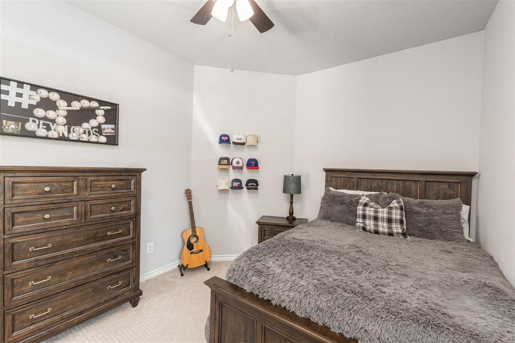 400 Prairie Run Aledo, TX 76008 - Photo 20 of 36 a bedroom with furniture and a chandelier