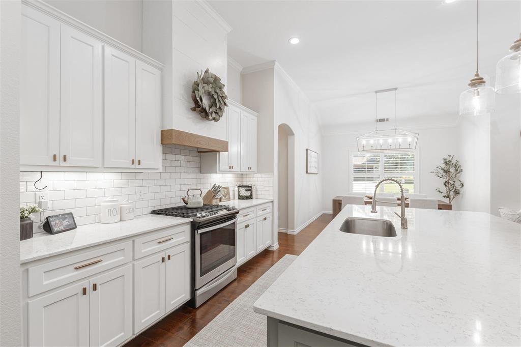 400 Prairie Run Aledo, TX 76008 - Photo 23 of 36 a kitchen with white cabinets and stainless steel appliances
