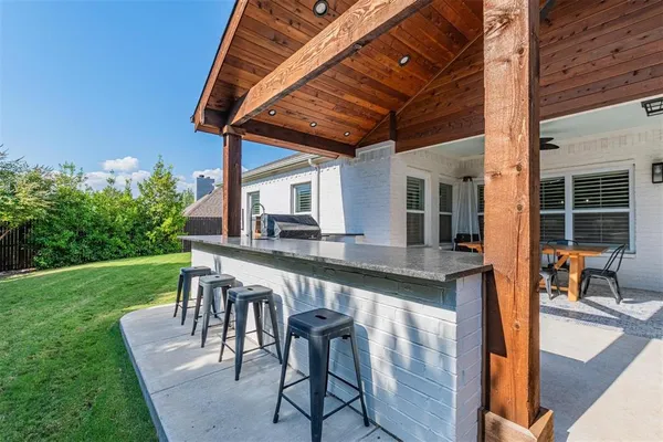 a balcony with table and chairs