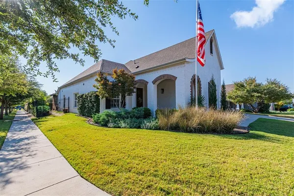 a front view of a house with yard and green space