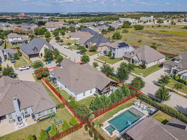 an aerial view of residential houses with outdoor space