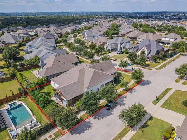 an aerial view of residential houses with outdoor space