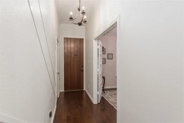 a view of a hallway with wooden floor and closet