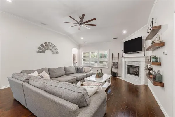 a living room with furniture a fireplace and a flat screen tv