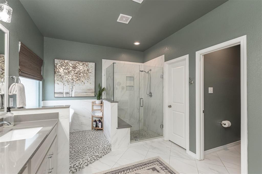 400 Prairie Run Aledo, TX 76008 - Photo 10 of 36 a spacious bathroom with a double vanity sink a large mirror a shower and a bathtub