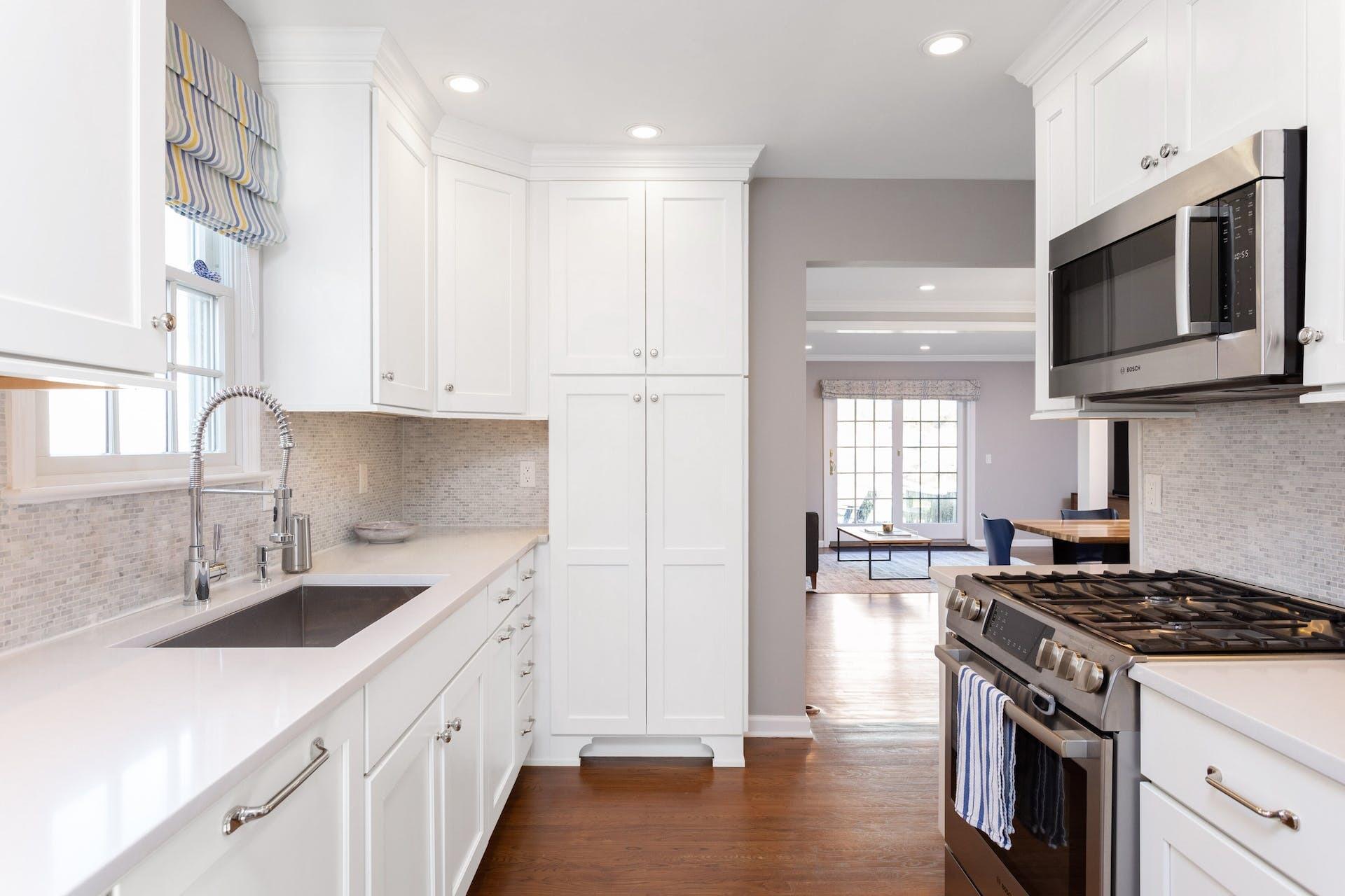 7 Devon Road Darien, CT 06820 - Photo 12 of 29 a kitchen with stainless steel appliances granite countertop a sink stove and microwave