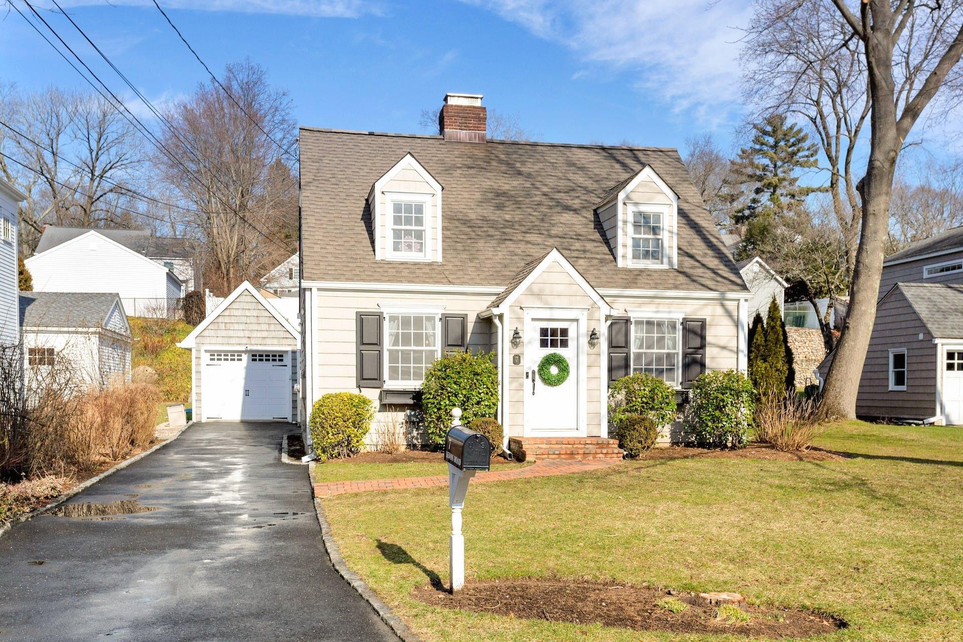 7 Devon Road Darien, CT 06820 - Photo 2 of 29 a front view of a house with swimming pool