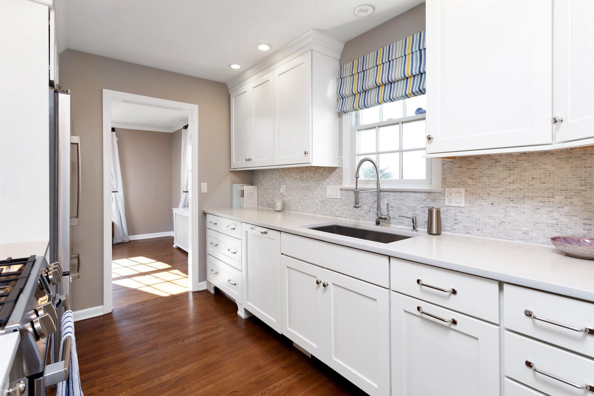 7 Devon Road Darien, CT 06820 - Photo 10 of 29 a kitchen with sink cabinets and wooden floor