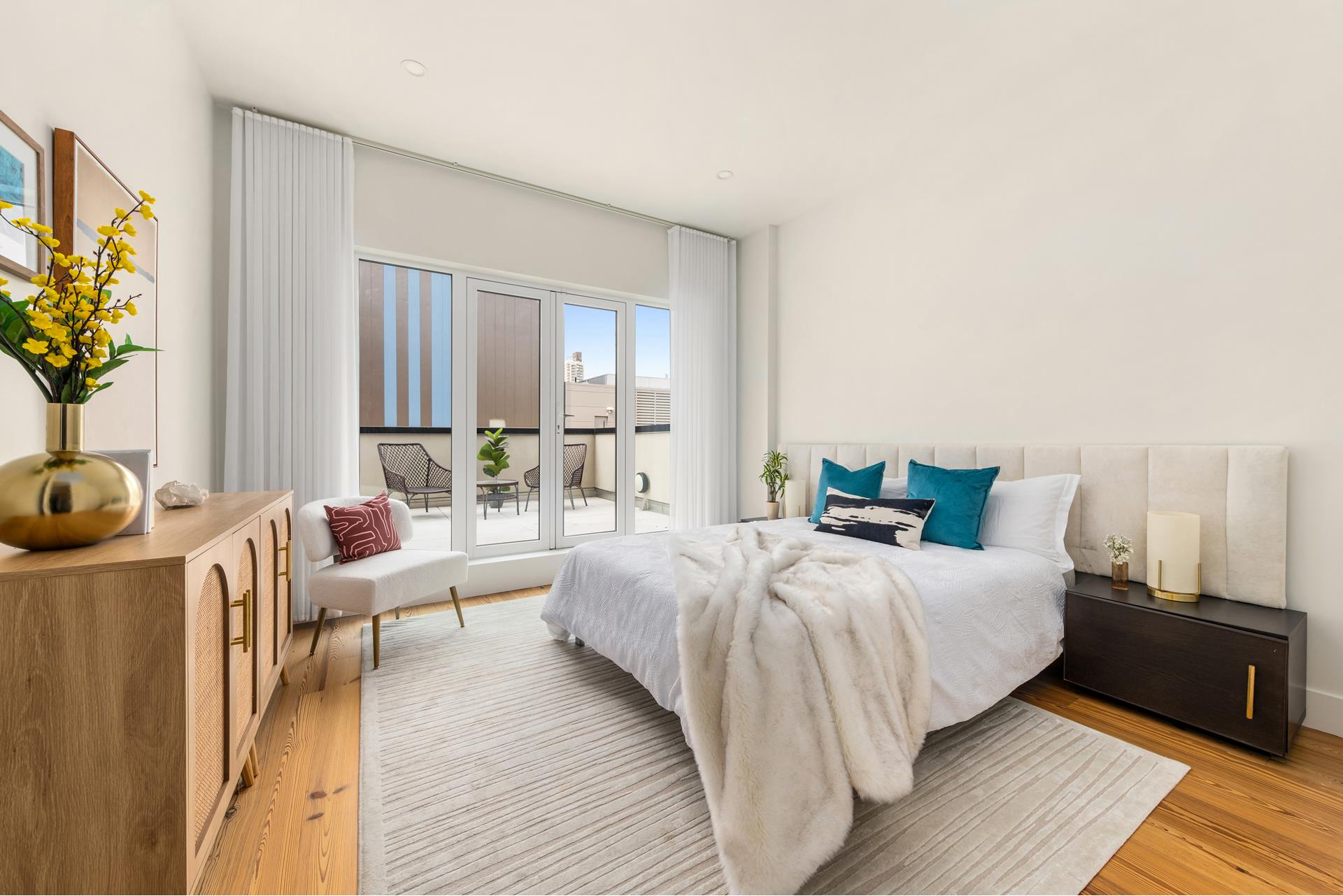 427 East 90th Street, Unit PH9 Manhattan, NY 10128 - Photo 28 of 37 a bed room with a bed and a couch