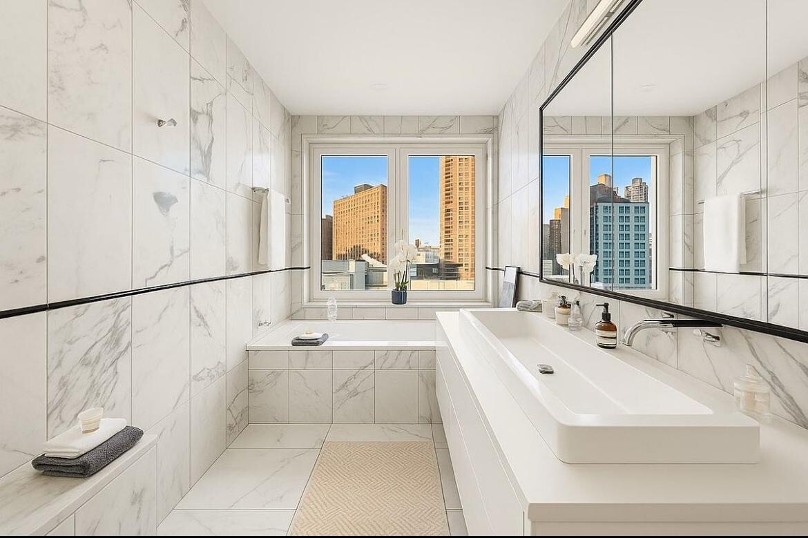 427 East 90th Street, Unit PH9 Manhattan, NY 10128 - Photo 8 of 37 a bathroom with a tub sink and mirror