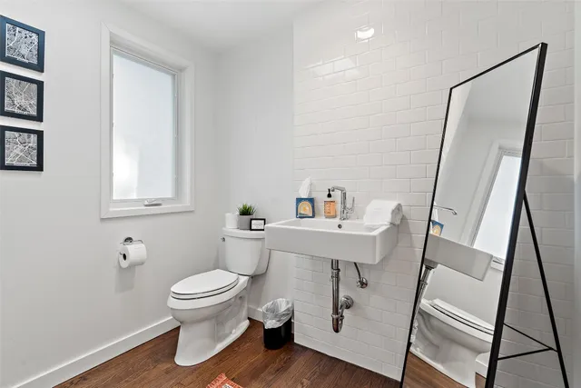 a white toilet sitting next to a bathroom sink