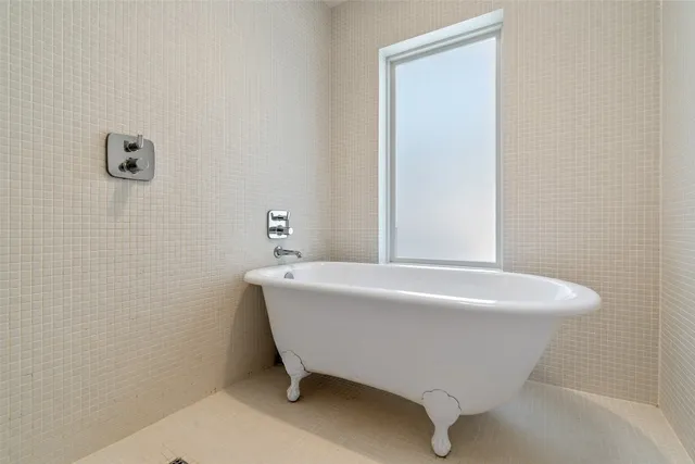 a white bath tub sitting next to a white sink