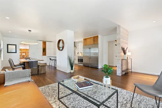 a living room with furniture and wooden floor