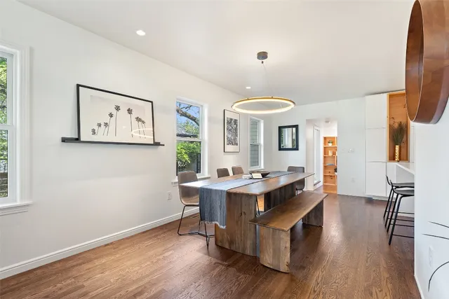 a view of a workspace with furniture and wooden floor